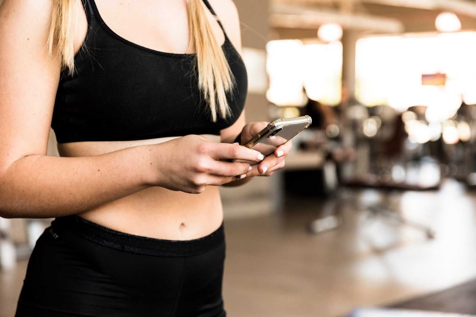 fitness-girl-using-her-mobile-phone